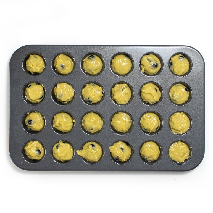 Muffin pan filled with batter. 