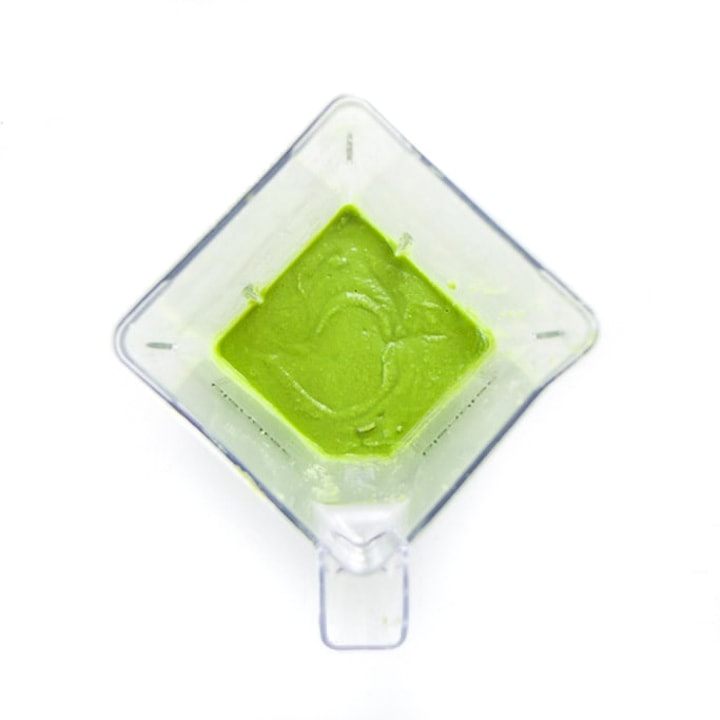 Blender full of blended green puree.