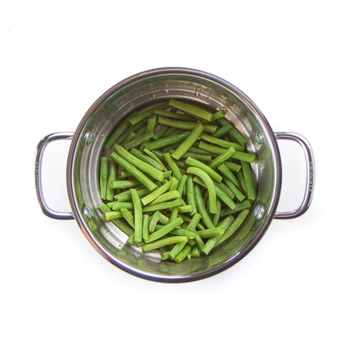 Steamer basket with green beans.