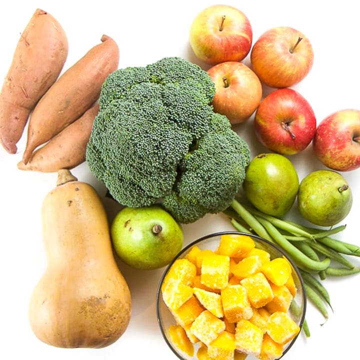 bunch of produce in a pile on a white background. 