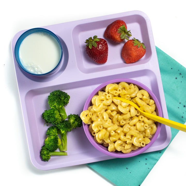 Purple school tray with instant pot Mac and cheese, broccoli and strawberries for a toddler or kid.