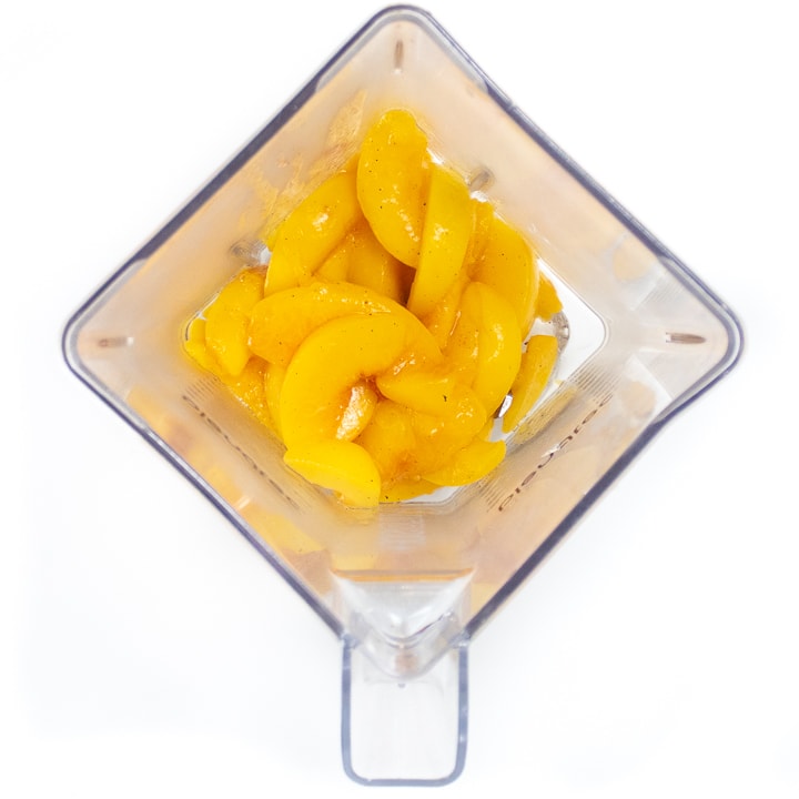 Blender full of cooked peaches.